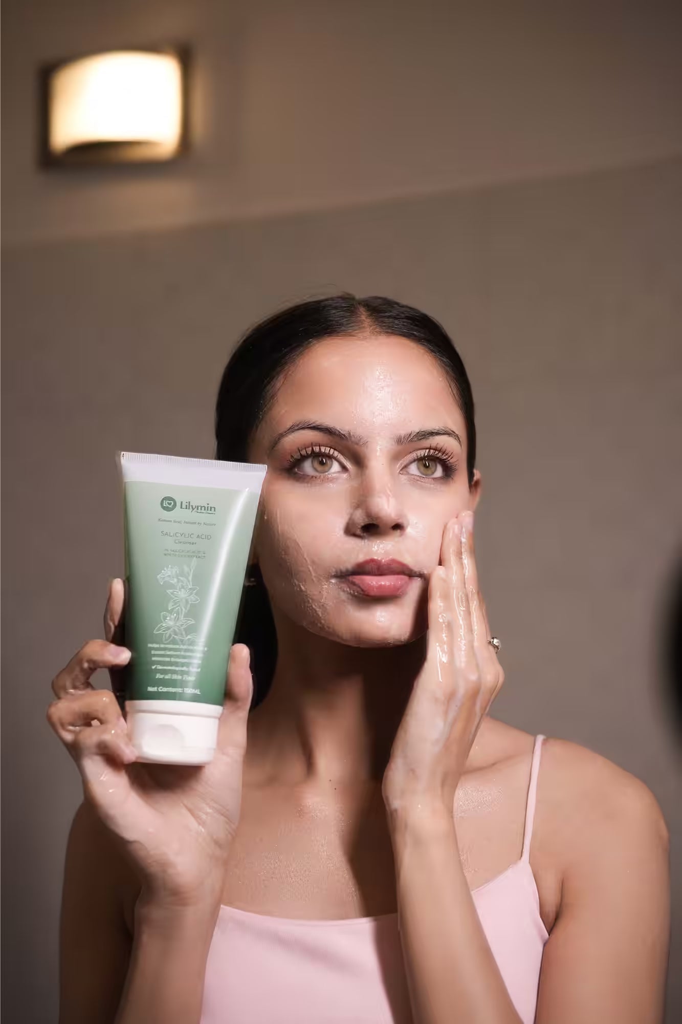 Apply a small amount to damp face